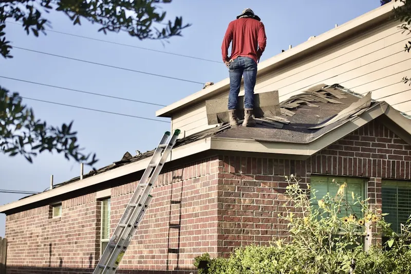 Professional roofer working on a residential roof in Peoria Heights